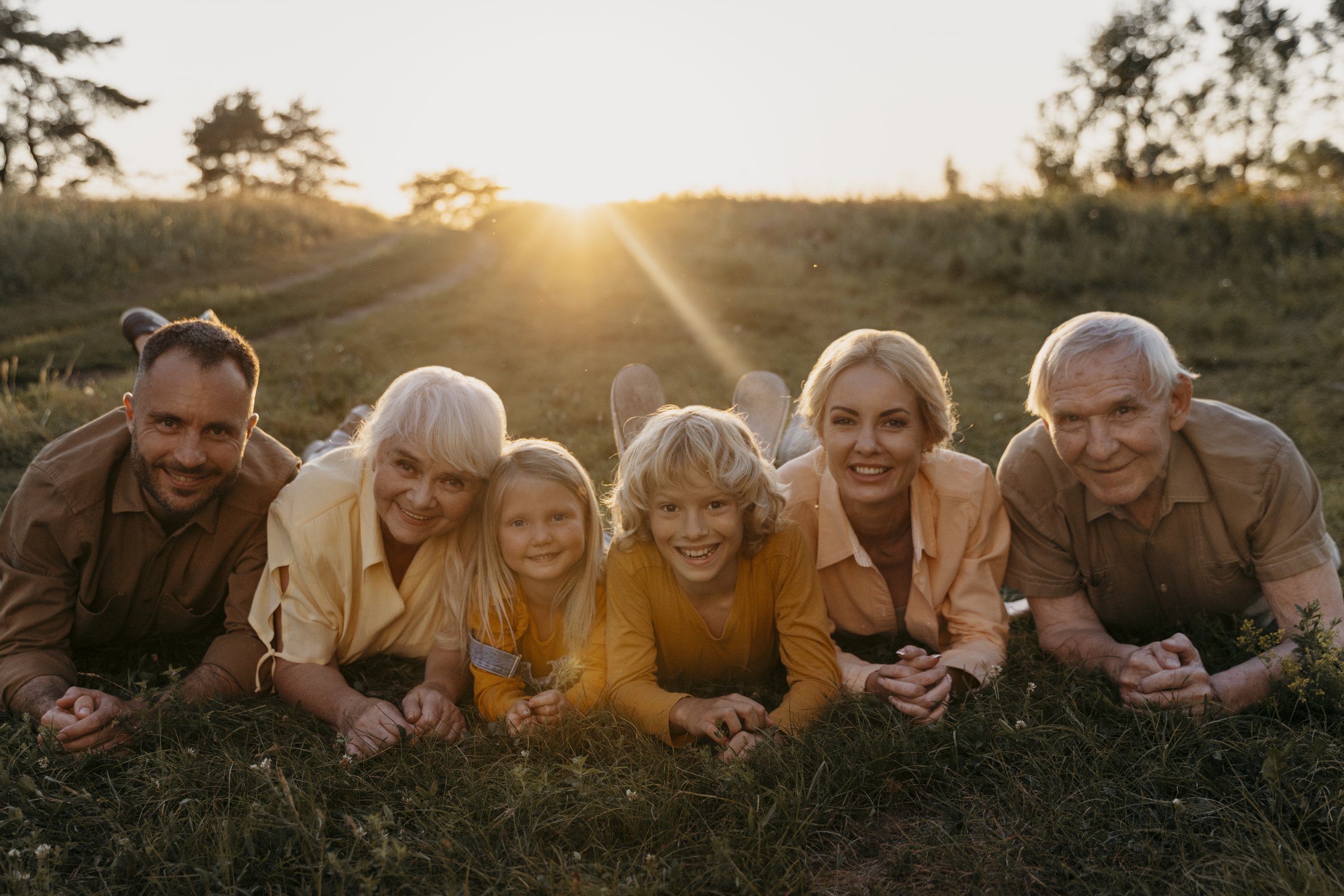 Three generations of a family together at sunset
